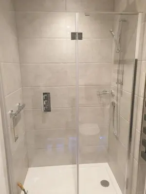 a bathroom with a shower with a glass door at Fly By - Duxford close to IWM & Wellcome Genome Campus in Duxford