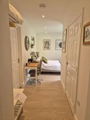 a bedroom with a bed and a desk with a desk at Fly By - Duxford close to IWM & Wellcome Genome Campus in Duxford