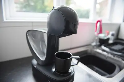 a coffee maker is making a cup of coffee at Mowbray Quarters of Cambridge in Cambridge