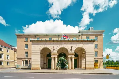 a building with a christmas tree in front of it at University Arms, Autograph Collection in Cambridge
