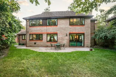 a brick house with a table in the yard at Spring Close in Colchester