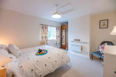 a bedroom with a large bed in a room at No. 10, The Cottage in Framlingham