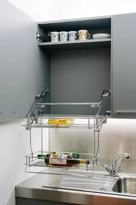 a kitchen sink with a shelf with a bottle of wine at Seahorse Studio, Aldeburgh in Aldeburgh