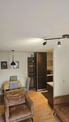 a living room with a couch and a table at The Retreat at Harlow in Potter Street