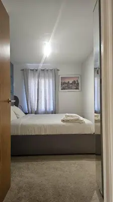 a bedroom with a large bed with a window at The Retreat at Harlow in Potter Street