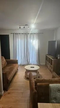 a living room with a couch and a table at The Retreat at Harlow in Potter Street