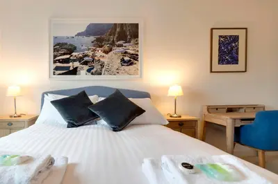 a bedroom with a white bed with black pillows at Pass the Keys Stunning and Spacious Modern Flat - Own Car Park in Cambridge