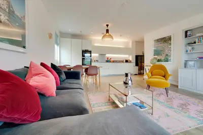 a living room with a couch and a table at Pass the Keys Stunning and Spacious Modern Flat - Own Car Park in Cambridge