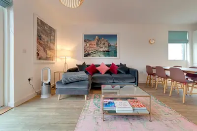a living room with a couch and a table at Pass the Keys Stunning and Spacious Modern Flat - Own Car Park in Cambridge