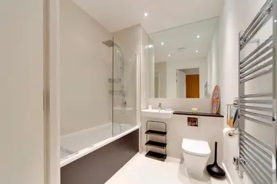 a bathroom with a toilet and a sink and a shower at Pass the Keys Stunning and Spacious Modern Flat - Own Car Park in Cambridge
