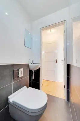 a bathroom with a white toilet and a sink at Pass the Keys Modern & Spacious 1 Bed Terrace with Free Parking in Cambridge