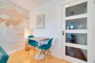 a small dining room with a table and chairs at Pass the Keys Modern & Spacious 1 Bed Terrace with Free Parking in Cambridge