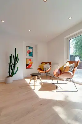 two chairs and a table in a room with a cactus at Pass the Keys 49 Byron Square Modern and Spacious 3 Bed Home with Free Parking in Cambridge