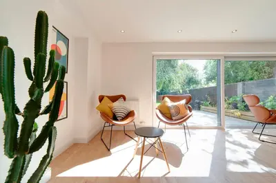 a room with three chairs and a cactus at Pass the Keys 49 Byron Square Modern and Spacious 3 Bed Home with Free Parking in Cambridge