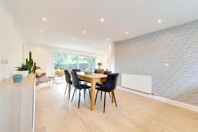 a dining room and living room with a table and chairs at Pass the Keys 49 Byron Square Modern and Spacious 3 Bed Home with Free Parking in Cambridge