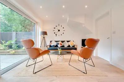 a living room with two chairs and a couch at Pass the Keys 49 Byron Square Modern and Spacious 3 Bed Home with Free Parking in Cambridge