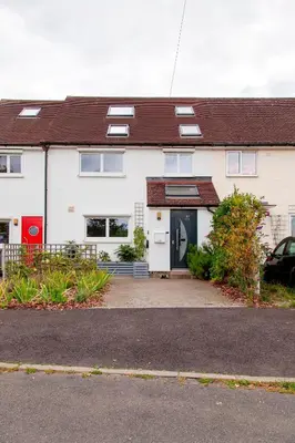 a white house with a driveway in front of it at Pass the Keys 49 Byron Square Modern and Spacious 3 Bed Home with Free Parking in Cambridge