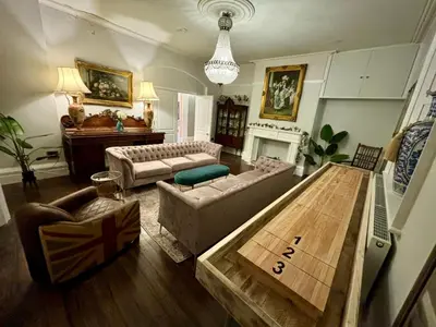a living room with a couch and a table at Luxury Georgian House With Sauna Sleeps 19-23 in Harleston