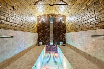 a swimming pool in a brick building with toilets at Luxury Georgian House With Sauna Sleeps 19-23 in Harleston