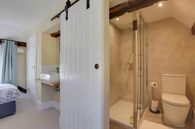a bathroom with a shower and a toilet and a sink at Josua Medieval Living Maldon in Maldon