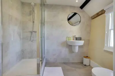 a bathroom with a shower and a sink at Josua Medieval Living Maldon in Maldon
