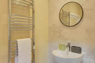 a bathroom with a sink and a mirror at Josua Medieval Living Maldon in Maldon