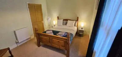 a bedroom with a bed with two lamps on it at Beautiful Spacious 5 Bed House in Fornham Saint Martin
