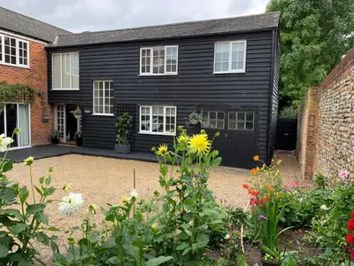 a black house with a garden in front of it at Beautiful Apartment Wendens Ambo in Wendens Ambo