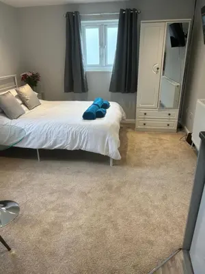 a bedroom with a bed with a blue stuffed animal on it at 29a in Downham Market