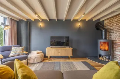 a living room with a couch and a fireplace at Granary Cottage in Wenhaston