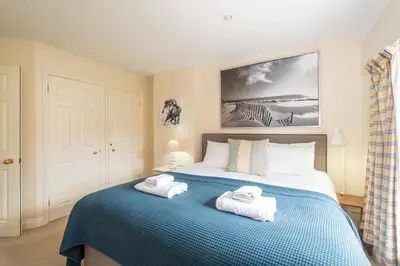 a bedroom with a bed with towels on it at Salt Cellar Cottage, Aldeburgh - Aldeburgh Coastal Cottages in Aldeburgh