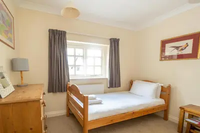 a small bedroom with a bed and a window at Salt Cellar Cottage, Aldeburgh - Aldeburgh Coastal Cottages in Aldeburgh