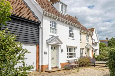 a white house with a black roof at Salt Cellar Cottage, Aldeburgh - Aldeburgh Coastal Cottages in Aldeburgh