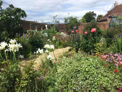 a garden with colorful flowers in a yard at STACK YARD COTTAGE. in Cambridge