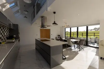 a kitchen and dining room with a table and chairs at The Mayfair in Six Mile Bottom