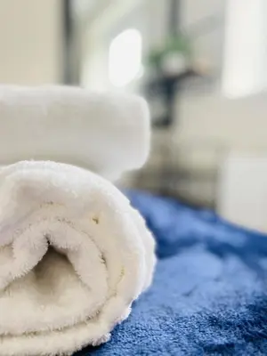 a roll of toilet paper sitting on top of a bed at Newmarket - Suffolk Flat with Garden EV in Newmarket