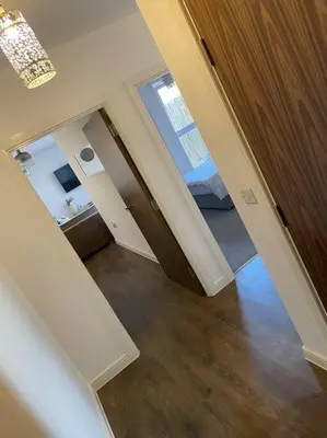 a room with a hallway with a bed and a mirror at Spacious Apartment in the Heart of Chelmsford in Chelmsford