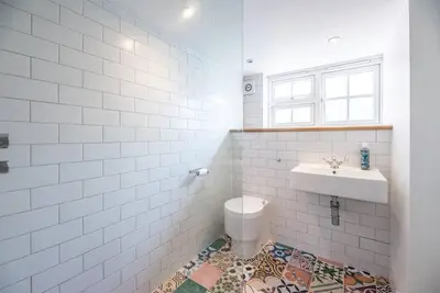 a bathroom with a sink and a toilet at Lilac Cottage, Wenhaston in Halesworth