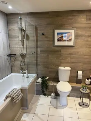 a bathroom with a toilet and a bath tub at The Courtyard Rooms in Brightlingsea