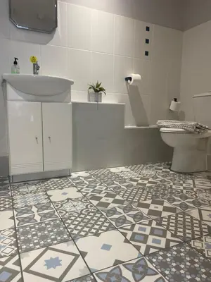 a bathroom with a sink and a toilet at The Courtyard Rooms in Brightlingsea