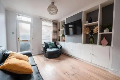 a living room with a couch and a tv at SuffStay in Ipswich