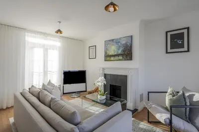 a living room with a couch and a fireplace at Luxurious 3 Bed House with Free Parking, Sky TV, Movies & Netflix in Braintree