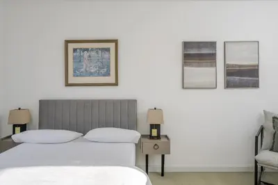 a bedroom with a bed and three pictures on the wall at Luxurious 3 Bed House with Free Parking, Sky TV, Movies & Netflix in Braintree