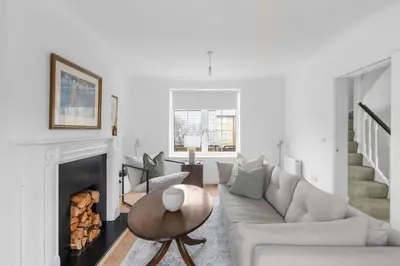 a living room with a couch and a fireplace at Luxurious 3 Bed House with Free Parking, Sky TV, Movies & Netflix in Braintree