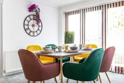 a dining room with a table and chairs at The Orange House Langdon Hills in Langdon Hills