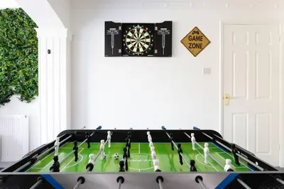 a play table with a dart board on the wall at The Orange House Langdon Hills in Langdon Hills