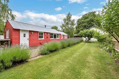 a red and white house with a yard at The Red Shed Entire home for 2 Private garden and parking 2 miles from Bury St Edmunds in Whepstead