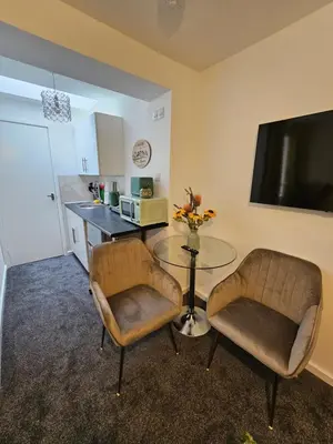a living room with a table and two chairs at Luxury Studio Stevenage in Stevenage