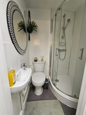a bathroom with a toilet and a shower and a sink at Luxury Studio Stevenage in Stevenage