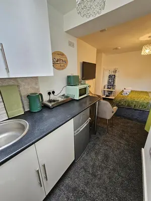 a kitchen with a sink and a microwave on a counter at Luxury Studio Stevenage in Stevenage